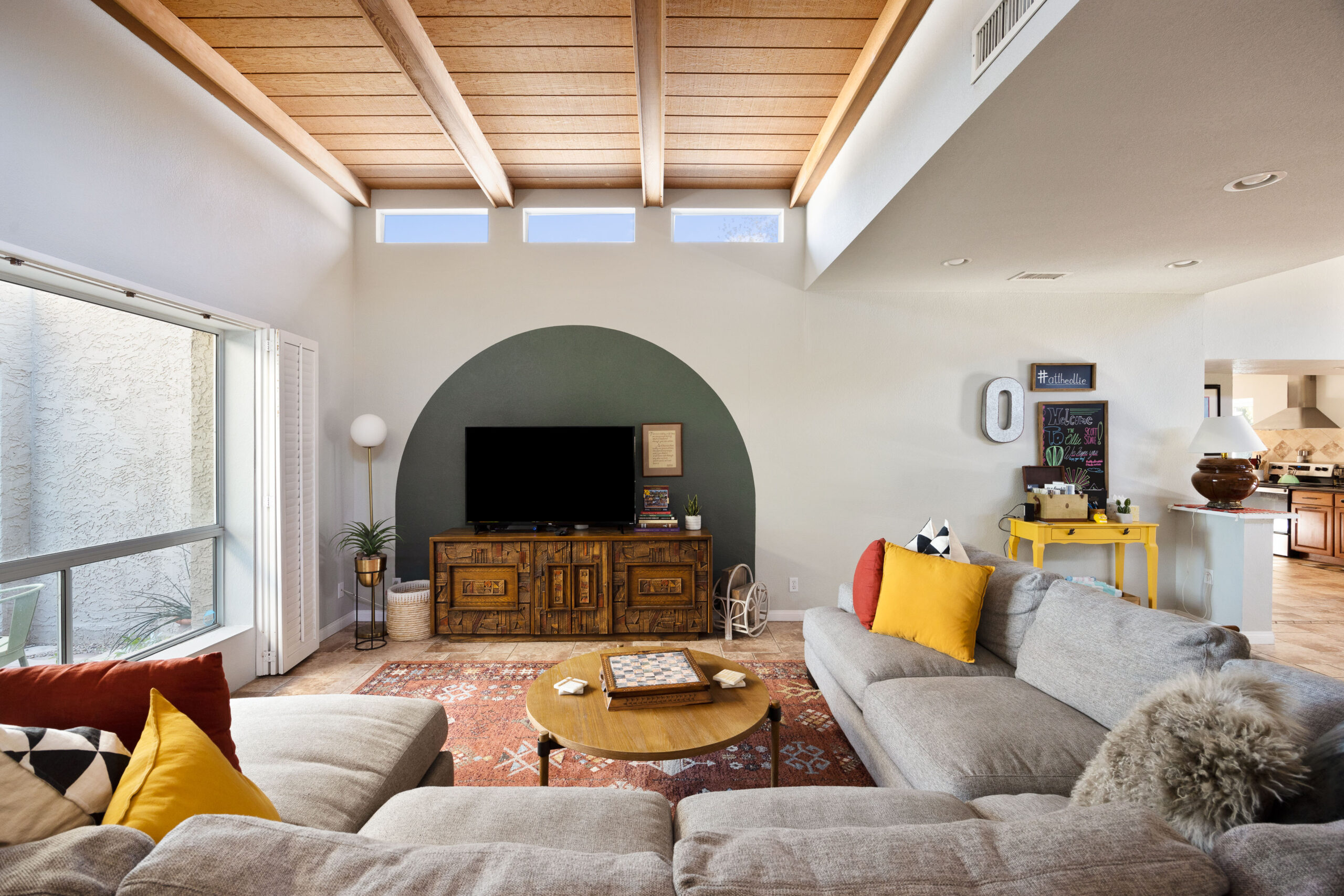 A living room with tongue and groove wood ceilings. It's clean and ready to sell!