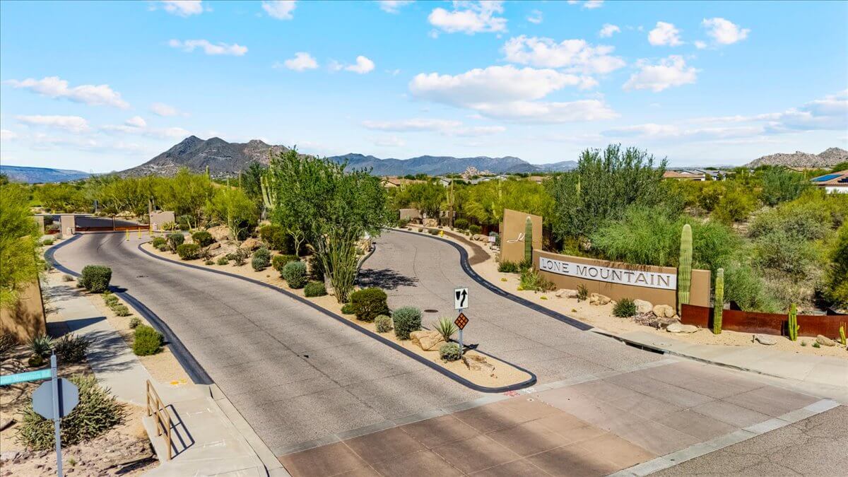 Entrance to Lone Mountain gated community in Cave Creek, AZ with desert landscaping and mountain views