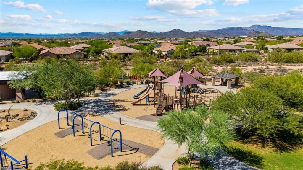 Community playground with slides, swings, and shaded play structures in Lone Mountain neighborhood Cave Creek AZ
