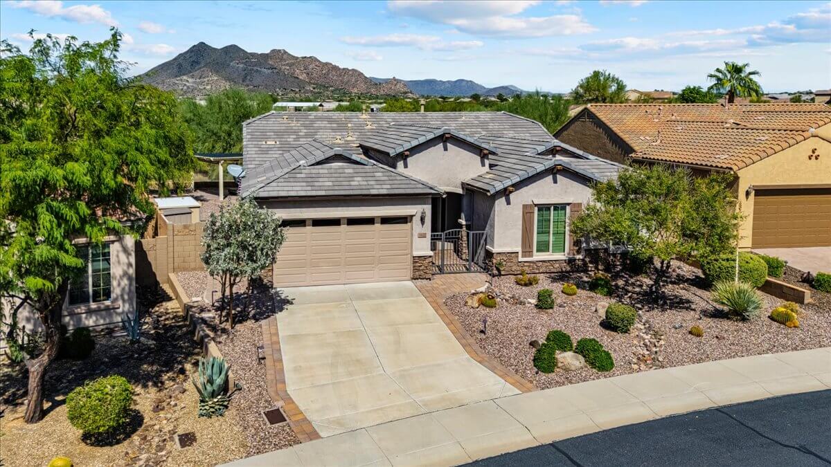 Front exterior view of a single-story home for sale in Lone Mountain gated community, Cave Creek AZ, with desert landscaping and mountain views