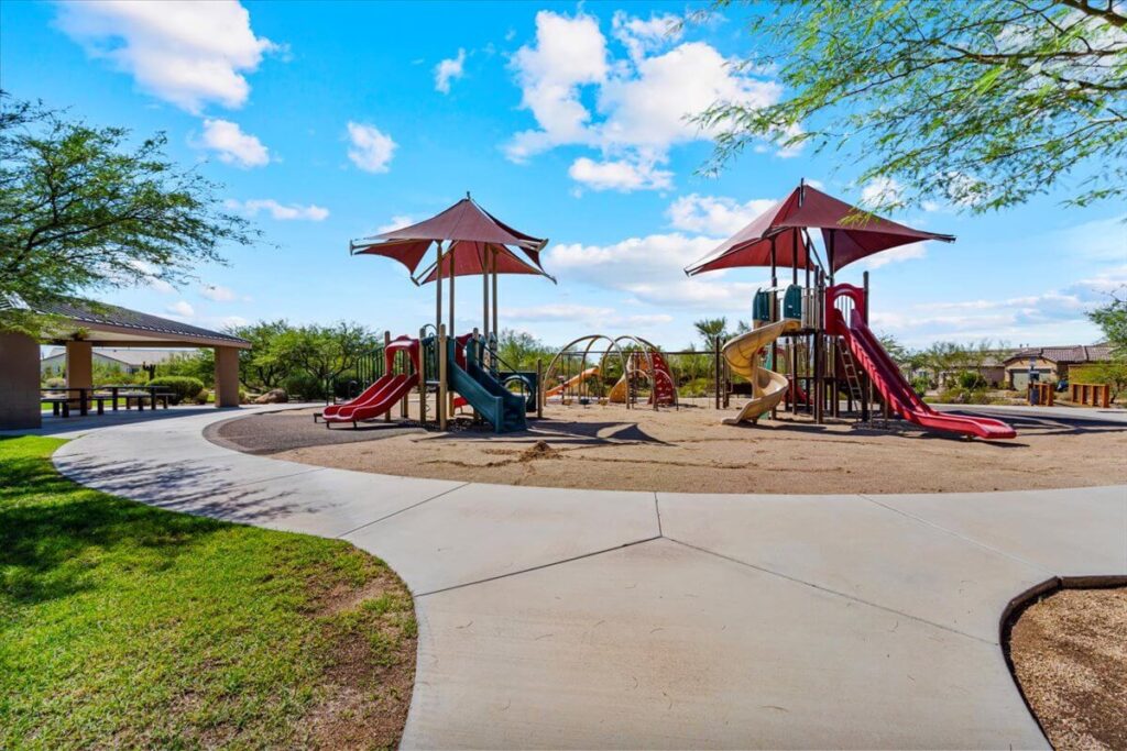 Playground with red slides and covered seating area in Lone Mountain community Cave Creek AZ
