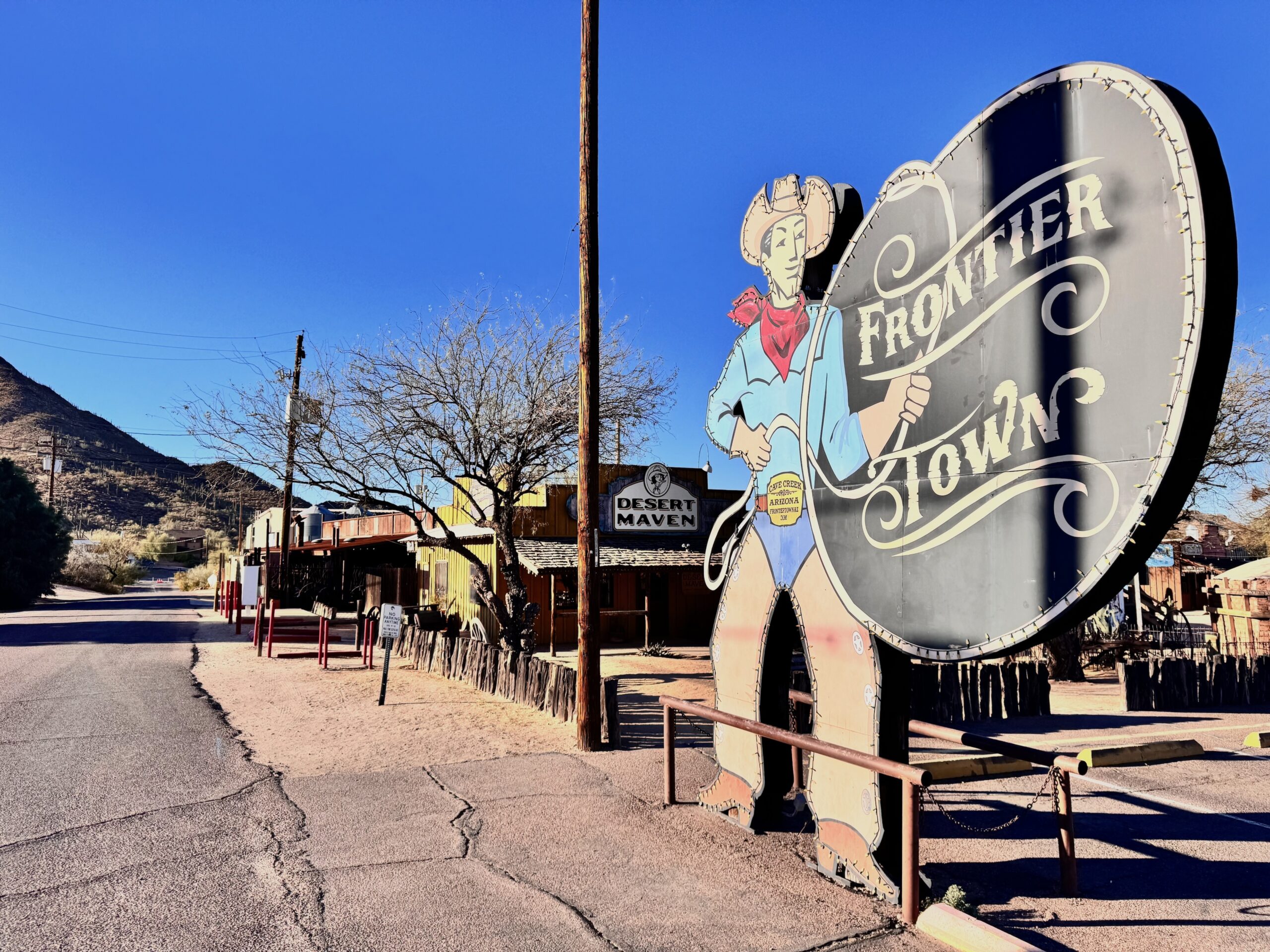 Frontier Town sign in Cave Creek Arizona on a sunny day, representing local holiday giving and community support in Cave Creek and Carefree.