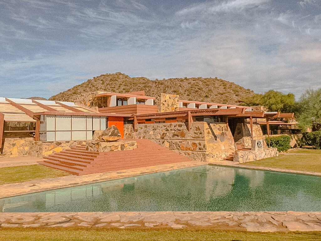 Taliesin West in Scottsdale, Frank Lloyd Wright's desert home, with its stone walls, red steps, and triangular pool under the McDowell Mountains